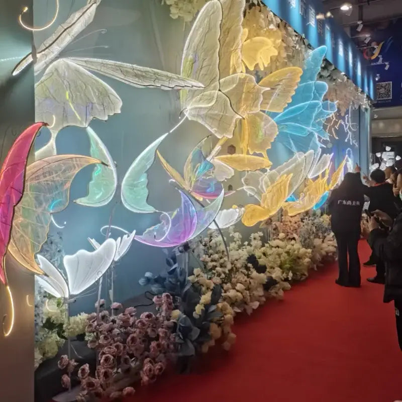 A vibrant decorbites blue lace led butterfly installation with glowing pink blue yellow and white translucent wings for bedroom decor