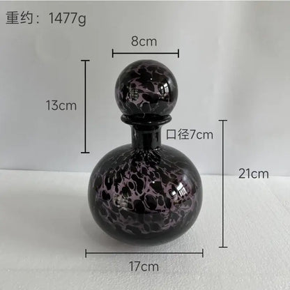 A sleek teal and black marbled leopard print glass vase with lid decorbites leopard print for living room decor