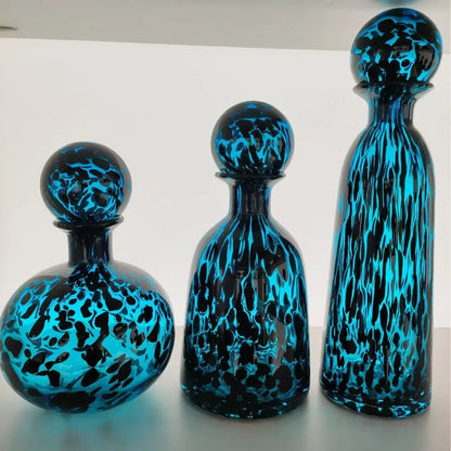 Three vibrant blue marbled leopard print glass vase decanters with spherical stoppers for living room decorbites decor