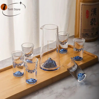 Clear glass decorbites blue sake glass set with blue mountain designs and matching sake glass ice measuring pitcher on wood tray