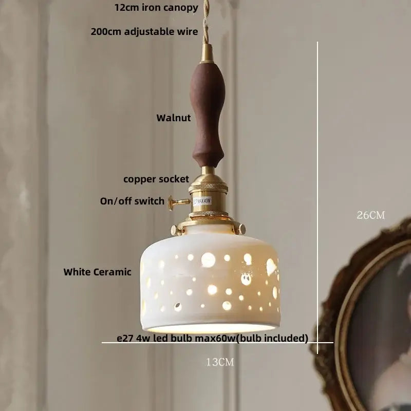 White ceramic led pendant lamp with walnut iron canopy and brass accents featuring decorative circular cutouts