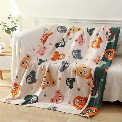 A plush gauze cotton bath towel with colorful cartoon bears on cream background for bedroom use