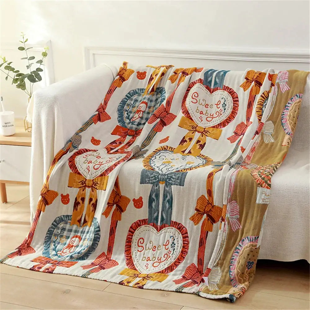 White gauze cotton bath towel featuring colorful hearts bows and sweet baby text in pastel tones for bedroom use