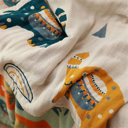 Blue teddy bear cotton bath towel featuring gauze cotton material with teal and mustard whale pattern