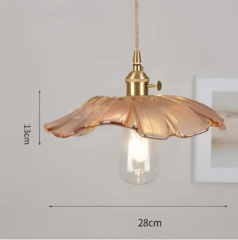 A delicate golden-toned glass pendant light with petal-shaped shade and exposed bulb from decorbites pendant lights