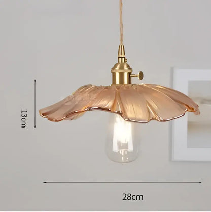 A delicate golden-toned glass pendant light with petal-shaped shade and exposed bulb from decorbites pendant lights