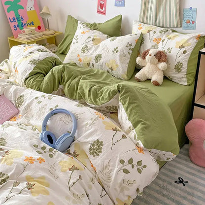 Light blue over-ear headphones resting on blue and white bunny cloud cotton printed bedding sets decorbites quilt set