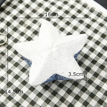 White star-shaped ceramic stress ball with speckled texture and blue base for decorbites ceramic marine life trays decor
