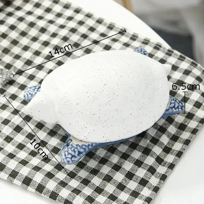 White ceramic marine life turtle figurine with blue patterned legs and speckled shell for decorbites ceramic marine decor