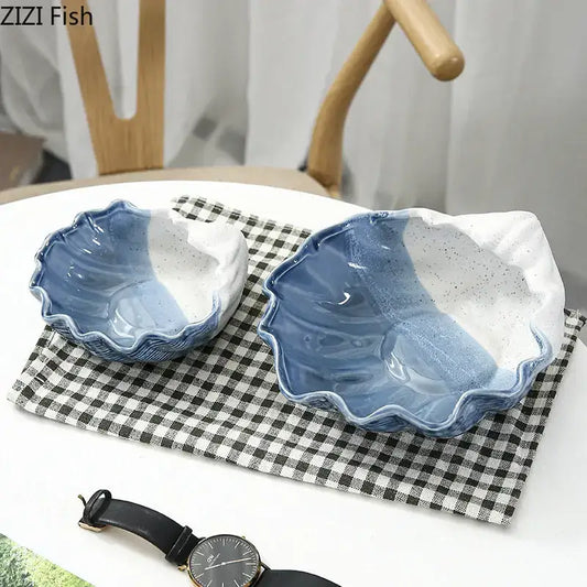 Two blue and white ceramic marine life clamshell trays with hand-painted gradient and speckled decorbites ceramic marine design