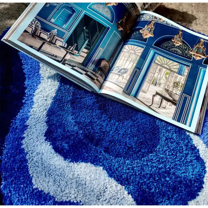 Open book displaying ornate blue and white room designs featuring decorbites cloud shaped tufted rug bathroom mat