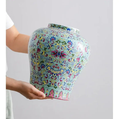 A vibrant blue white porcelain floral vase with intricate pink, yellow, and green decorbites blue white patterns