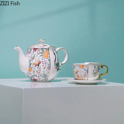 Delicate blue white porcelain coffee mug and teacup set with floral orange blossoms purple flowers and gold trims decorbites blue white