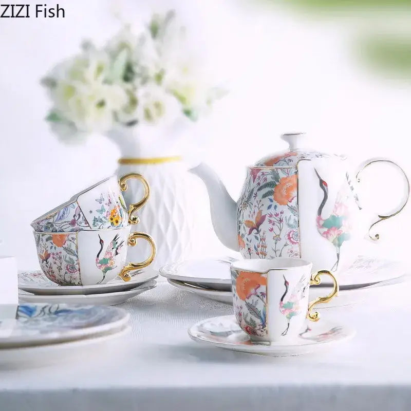 Elegant blue white porcelain coffee mug with gilded handles featuring vibrant floral and crane motifs for decorbites