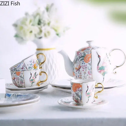 Elegant blue white porcelain coffee mug with gilded handles featuring vibrant floral and crane motifs for decorbites