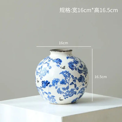 A round white porcelain gourd teapot vase with intricate blue floral patterns and a textured rim for living room decor