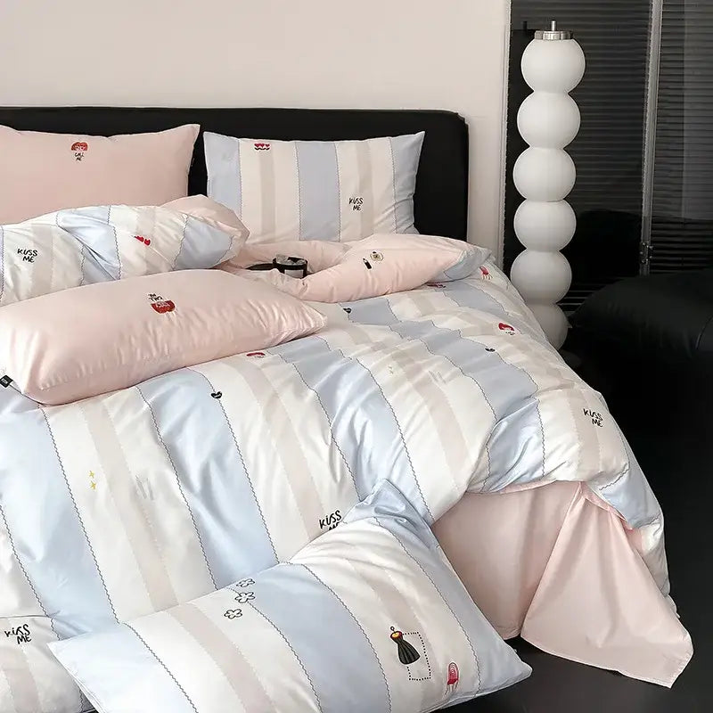 Pastel blue and white striped duvet cover set with embroidered kiss me text and small cartoon motifs for bedroom use