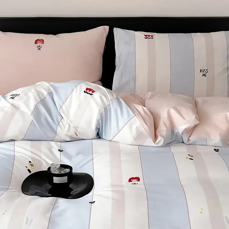 Pastel blue and pink striped duvet cover set with embroidered kiss me text and red heart designs for bedroom use