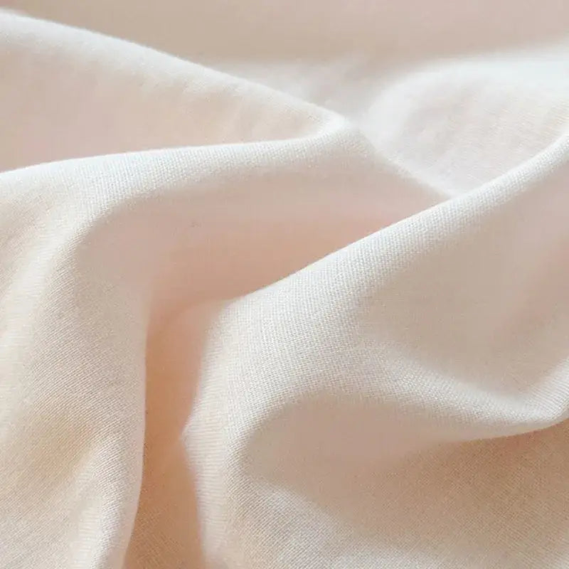 Soft off-white cotton fabric with gentle sheen and subtle texture in blush pink and gray cotton edge embroidery bedding set