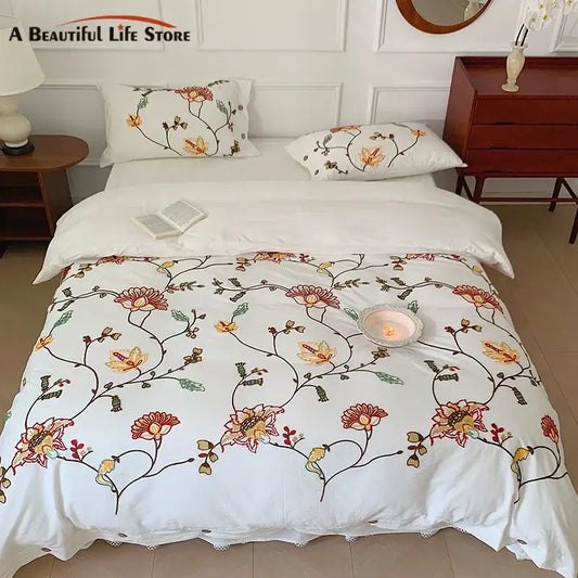 White cotton duvet cover bedding set with intricate bohemia floral embroidery in red orange yellow and green by decorbites