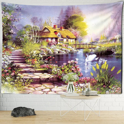 A vibrant decorbites forest tapestry wall hanging depicting a thatched cottage by a pond with swans and flowers