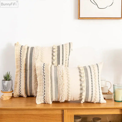 Beige and gray striped throw pillows with textured fringe pom-poms and woven details bohemian beige cushion cover decorbites
