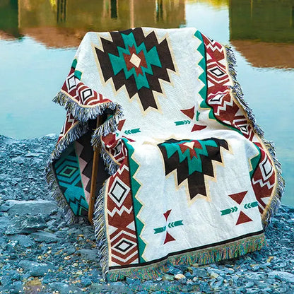 White woven bohemian sofa blanket with bold teal brown red geometric patterns and fringed edges vintage plaid design decorbites