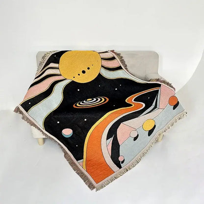 A decorbites bohemian classic woven throw blanket with vibrant cosmic design in pastel pinks on black background