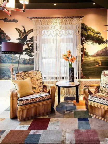 Rattan armchairs with woven bamboo frames and patterned upholstery alongside decorbites bohemian cotton macrame wall hanging decor