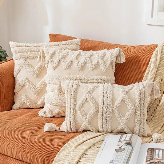 Cream-colored textured cushion covers with woven geometric patterns and tassels for decorbites bohemian tassel living room decor