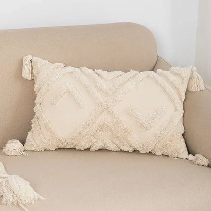 Cream-colored rectangular cushion cover with textured fringed fabric and tassels for decorbites bohemian tassel living room decor