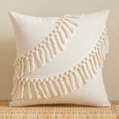 Cream-colored cotton cushion cover with two diagonal rows of macrame fringe for living room decor by decorbites bohemian tassel