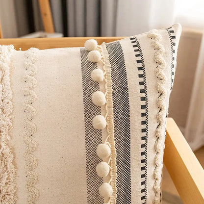 Cream-colored bohemian cotton cushion cover with black and white stripes and fluffy pom-poms for living room decorbites decor