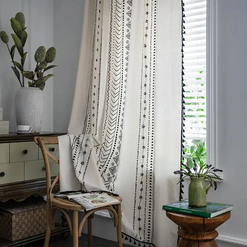 Cream-colored curtains with black ethnic geometry printed patterns and tassel trim for bohemian ethnic decorbites living room