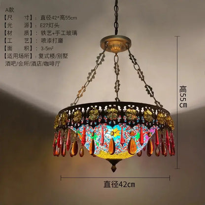 A vibrant handcrafted bohemian exotic stained glass pendant light with gold red beads and black wrought iron frame for dining room