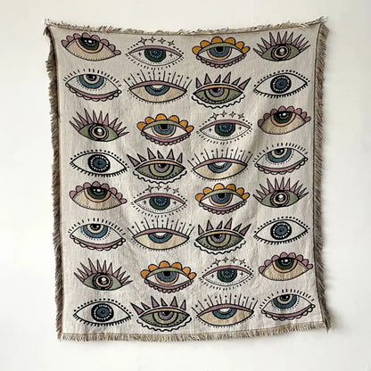 Beige woven bohemian throw blanket with colorful stylized eyes pattern and frayed edges for living room decorbites throw blanket