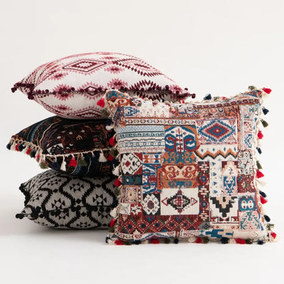Vibrant patchwork cushion cover with intricate geometric and tribal patterns and colorful tassels for bohemian flower decorbites style