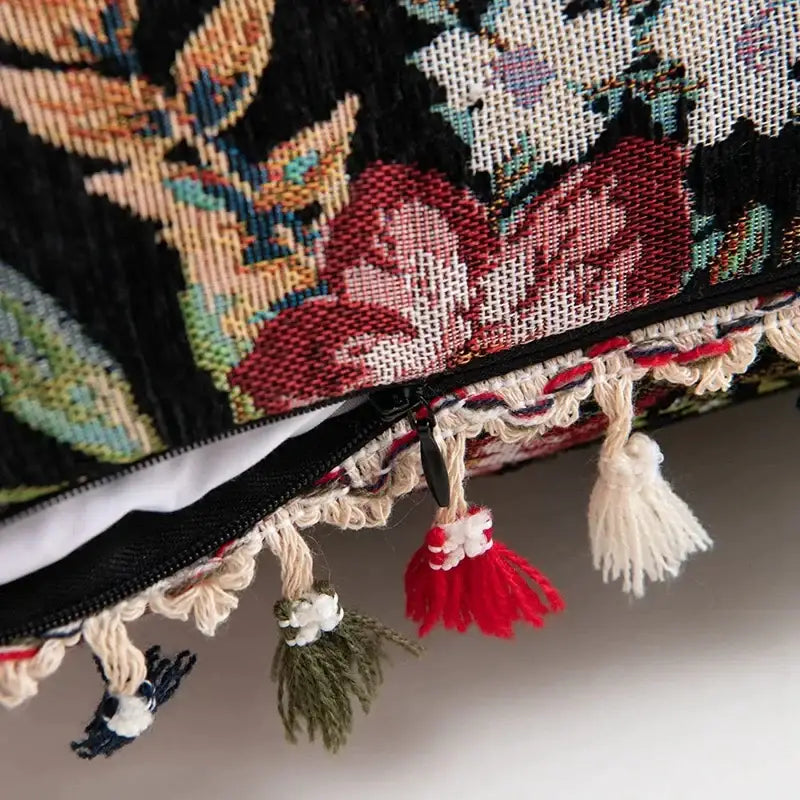 Decorbites bohemian flower cushion cover featuring a richly woven black floral tapestry with colorful tassels for living room decor