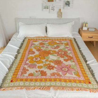 A cream vintage-style sofa blanket with colorful bohemian flowers, fringed edges, and decorbites bohemian flowers design