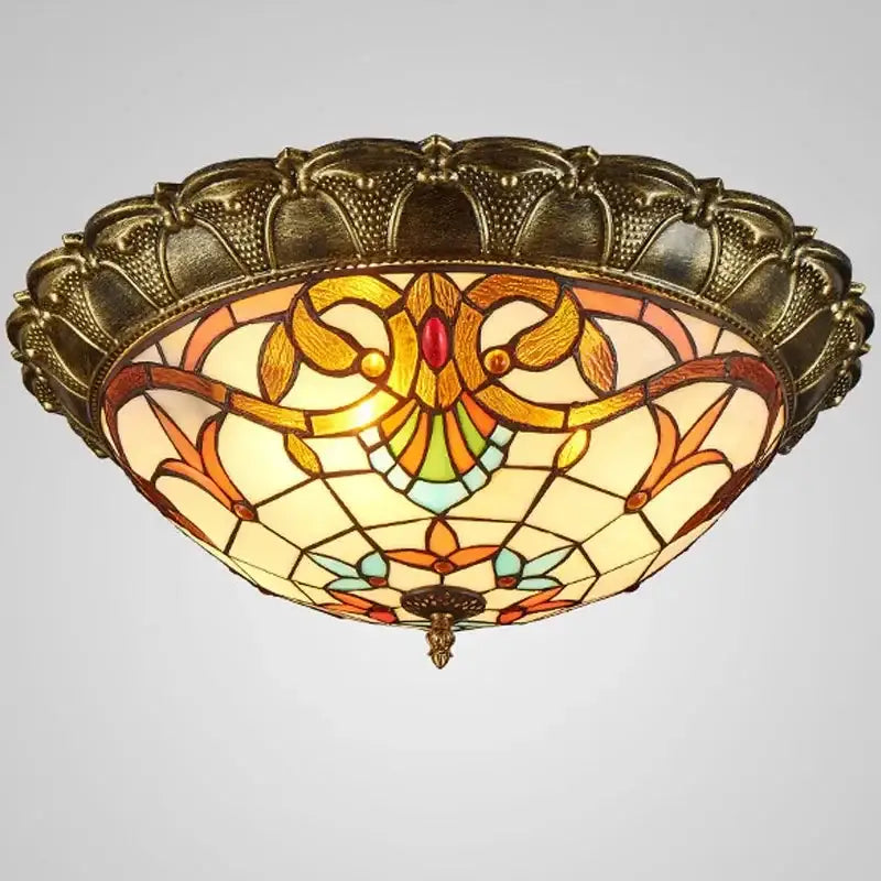 Antique brass-finished decorbites bohemian glass ceiling light with amber stained glass and floral leaf patterns