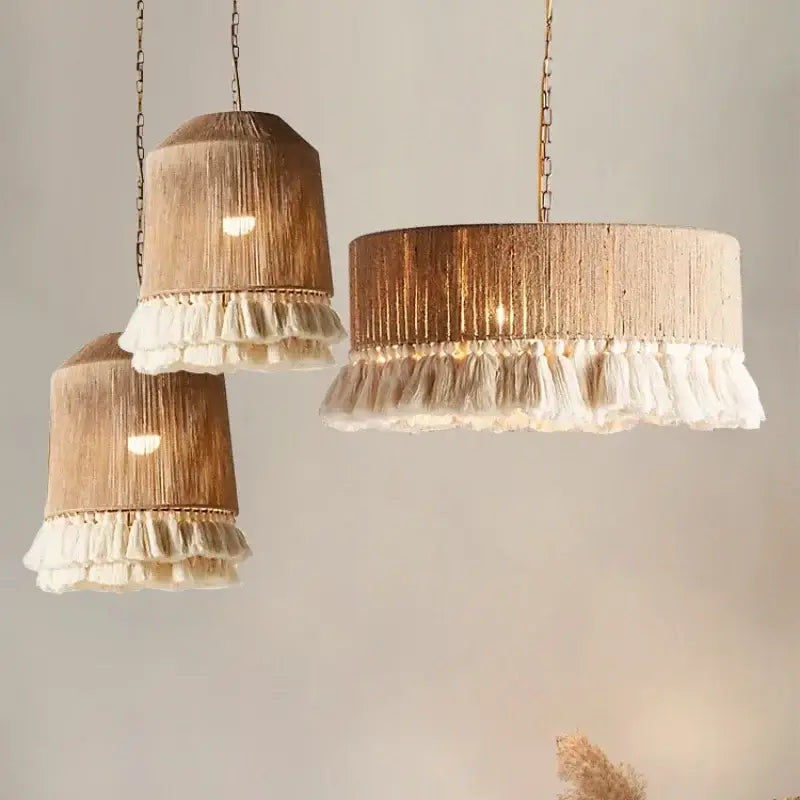 Three rustic pendant lights with natural wood-toned woven bodies and white tassel fringe bohemian hemp rope decorbites