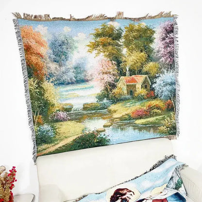 Bohemian jacquard sofa blanket featuring a woven pastoral autumn scene with trees cottage and river under blue sky