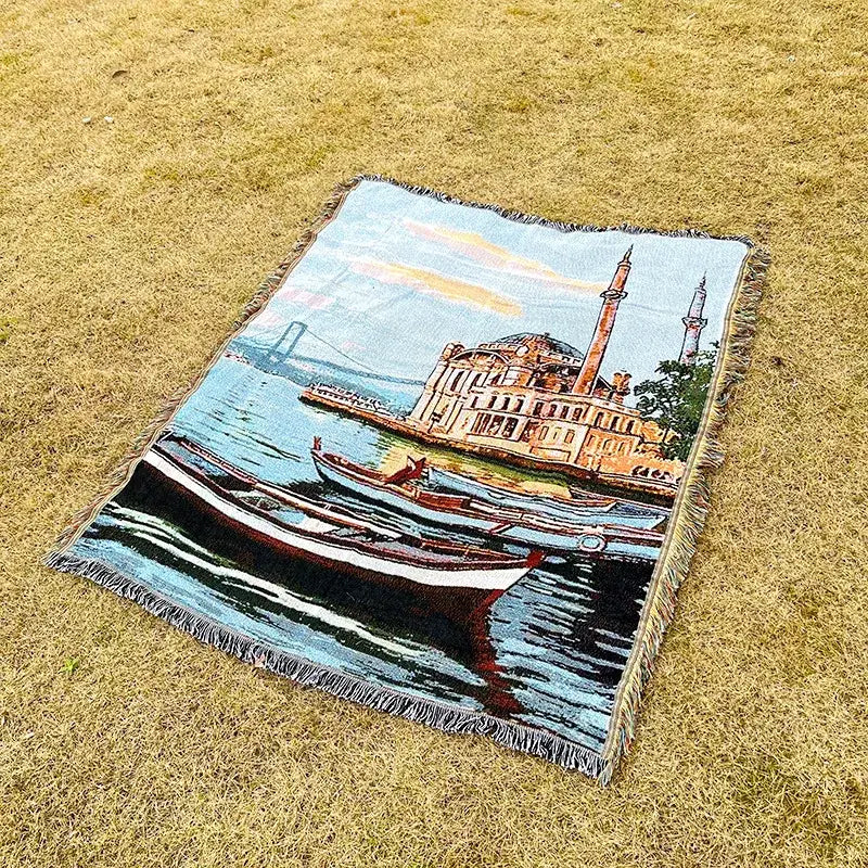 Bohemian jacquard sofa blanket featuring a vibrant woven tapestry of boats and mosque in a pastoral autumn scene