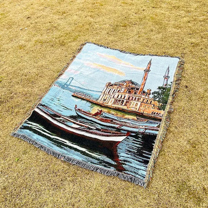 Bohemian jacquard sofa blanket featuring a vibrant woven tapestry of boats and mosque in a pastoral autumn scene