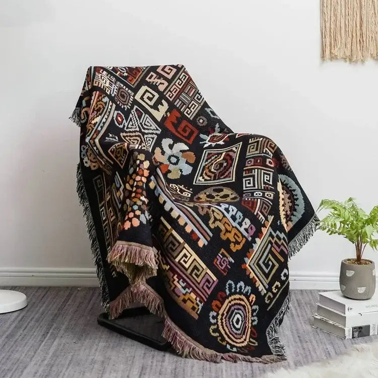 Black and red bohemian jacquard throw blanket with intricate geometric tribal patterns and fringed edges for living room decor