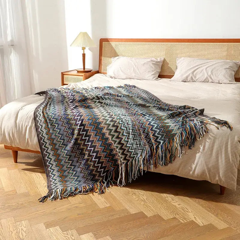 Bohemian knit tassel multicolored zigzag throw blanket with fringed edges in blue gray and brown for bedroom decor