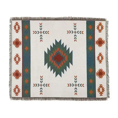 White woven bohemian knit throw blanket with teal rust diamond pattern and fringed edges for living room decorbites decor