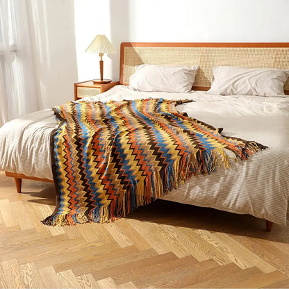 Bohemian knitted blanket with vibrant yellow blue orange and brown zigzag pattern and fringed edges for living room