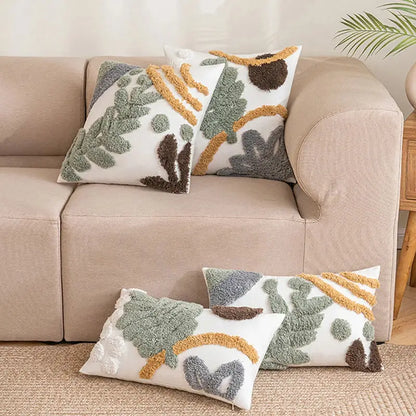 White plush cushion cover with textured tufted green brown and mustard yellow leaf patterns bohemian loop design