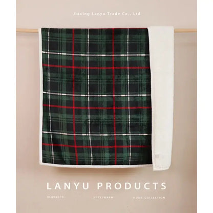 A cozy green red and white plaid coral fleece sofa blanket with soft fleece lining for winter comfort